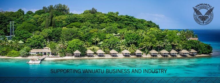 Blue beach in Vanuatu with a thick forest behind