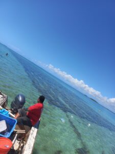 Man on Boat Over Clear Ocean Water in Tonga