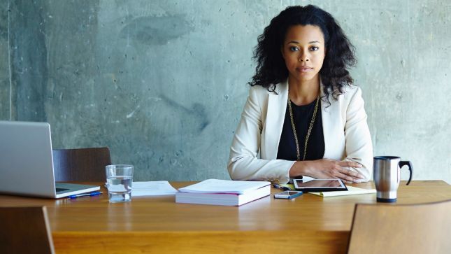 The professional woman is waiting at the desk for her clients