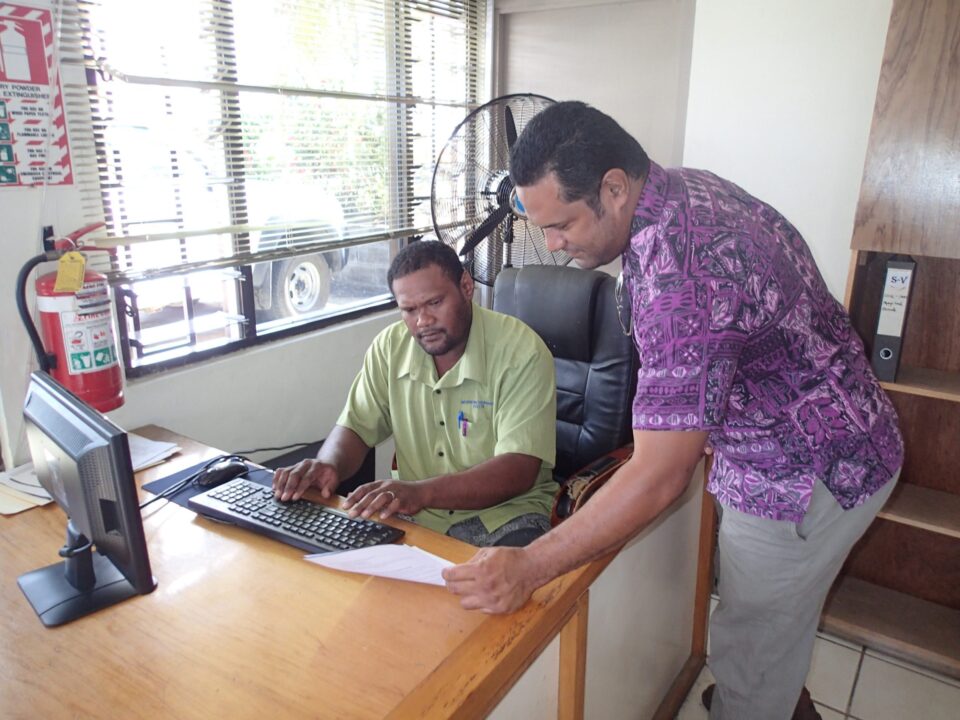 Two guys are working together at the office