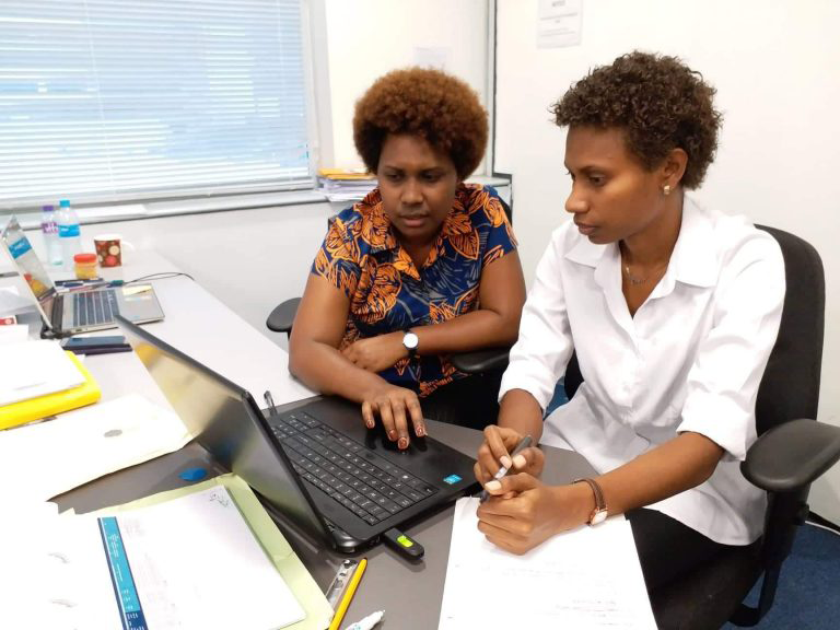 A woman is learning from her workmate about the new project