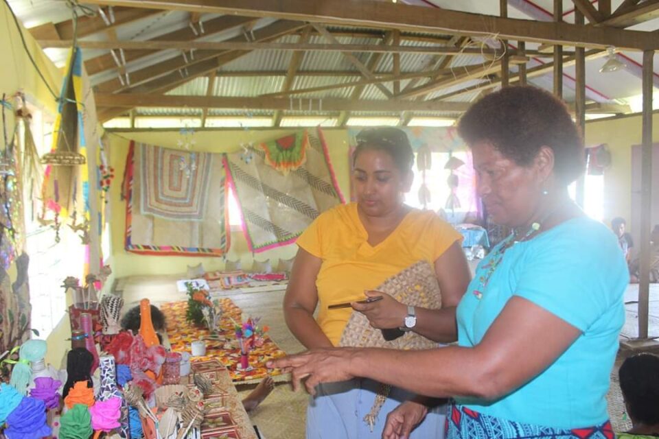 Two girls are enjoying the exhibition of native items