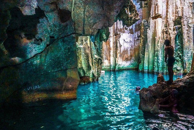 Water flooded caves with visitors swimming