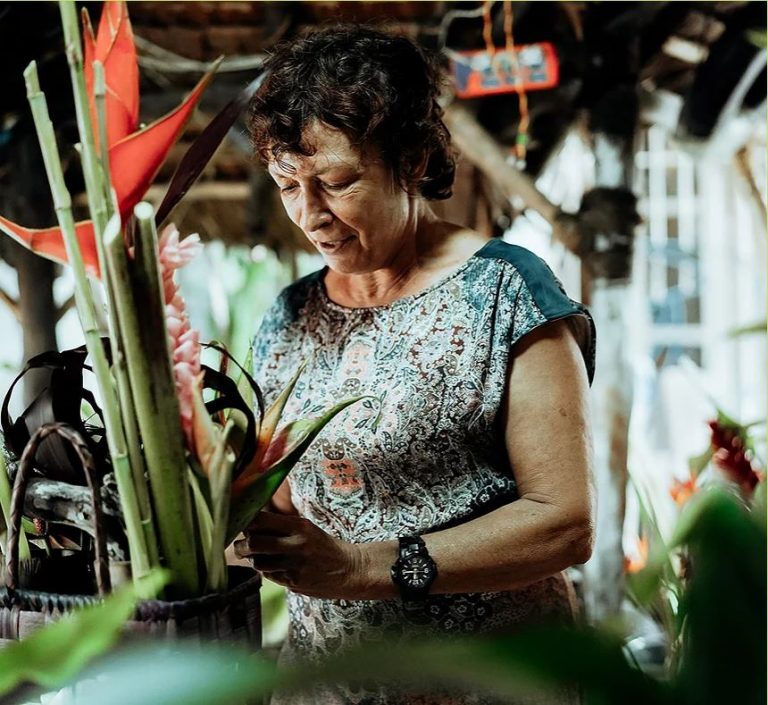 A woman making a floral bouquet