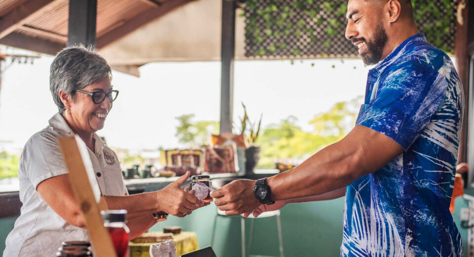 Small business owner and customer exchanging product