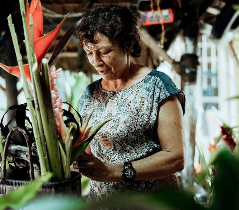 A woman making a floral bouquet