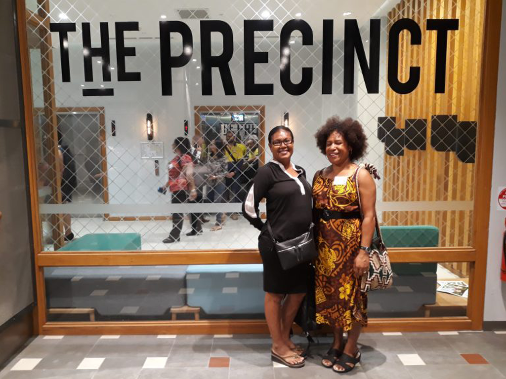 two women smiling in office reception