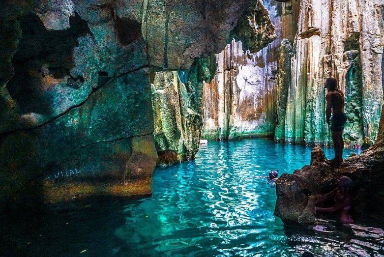 Water flooded caves with visitors swimming