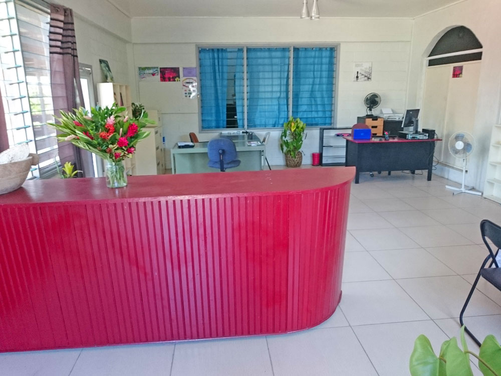 red reception desk at Samoan office