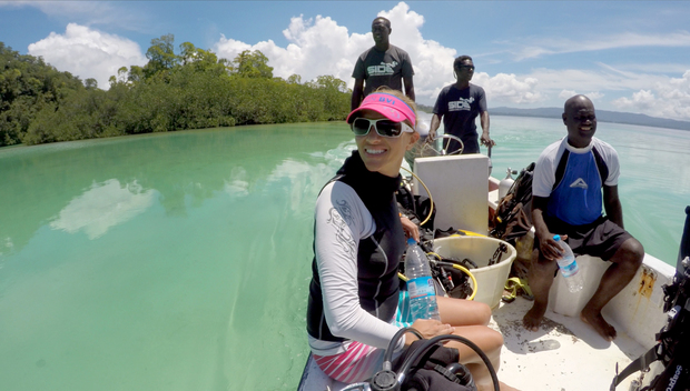 Dive Munda owner Belinda Botha on boat with local staff