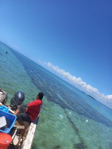 Man on Boat Over Clear Ocean Water in Tonga